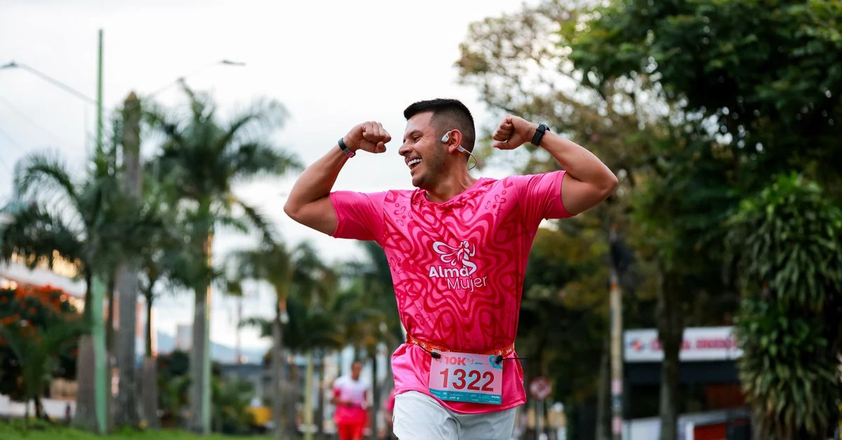 10kmロードレース中にGPSウォッチの心拍数を確認する市民ランナー